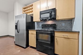 A kitchen with stainless steel appliances and wooden cabinets